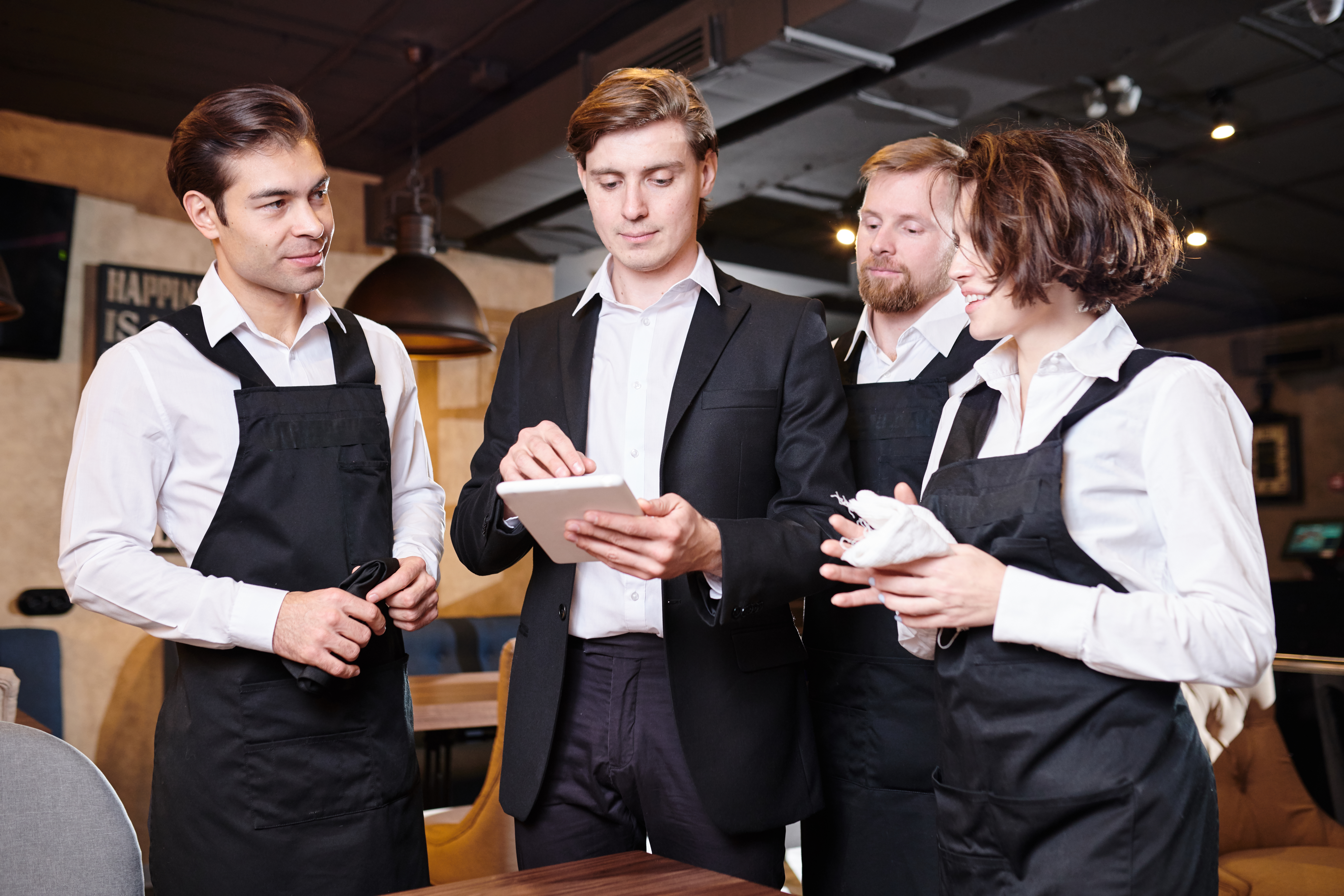 Serious restaurant manager dividing responsibilities among waite Google Review 5 Stars